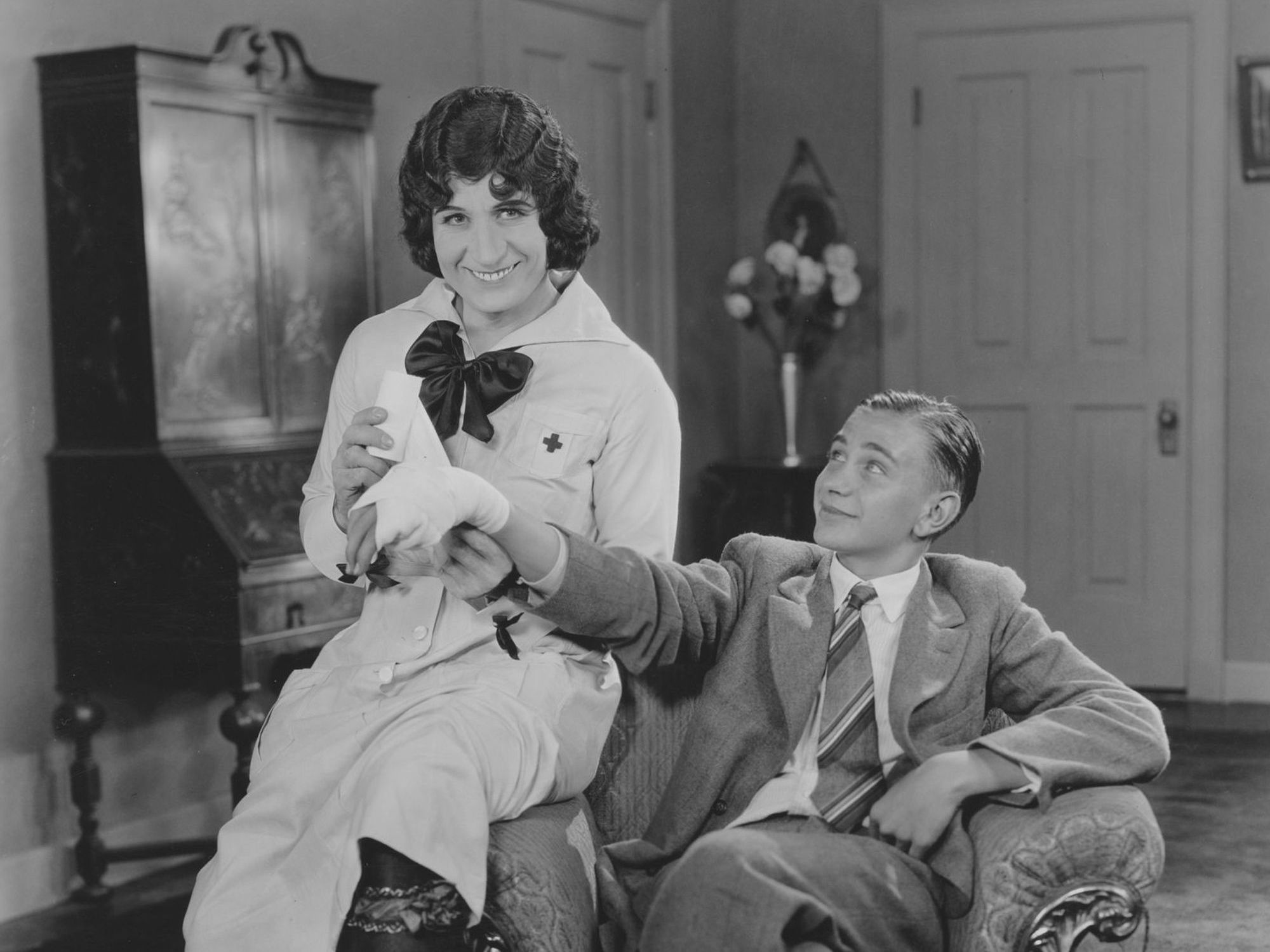 English actor Sydney Chaplin (left) pictured wearing a nurse's uniform from the film 'Oh What a Nurse!', circa 1926. (Photo by FPG/Getty Images)
